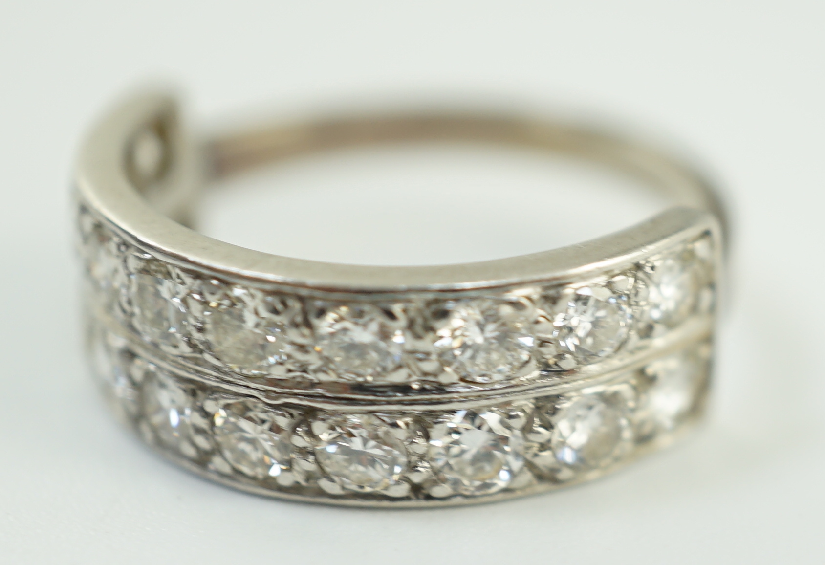 A white gold and two row twenty stone diamond set half eternity ring